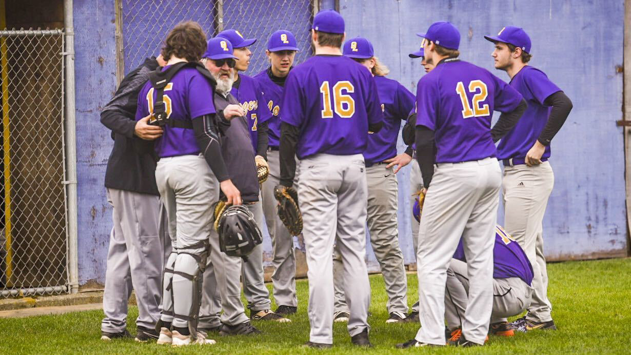 Onalaska baseball coach Rocky Stanley talks to his team between innings during a home game against Winlock on March 31.